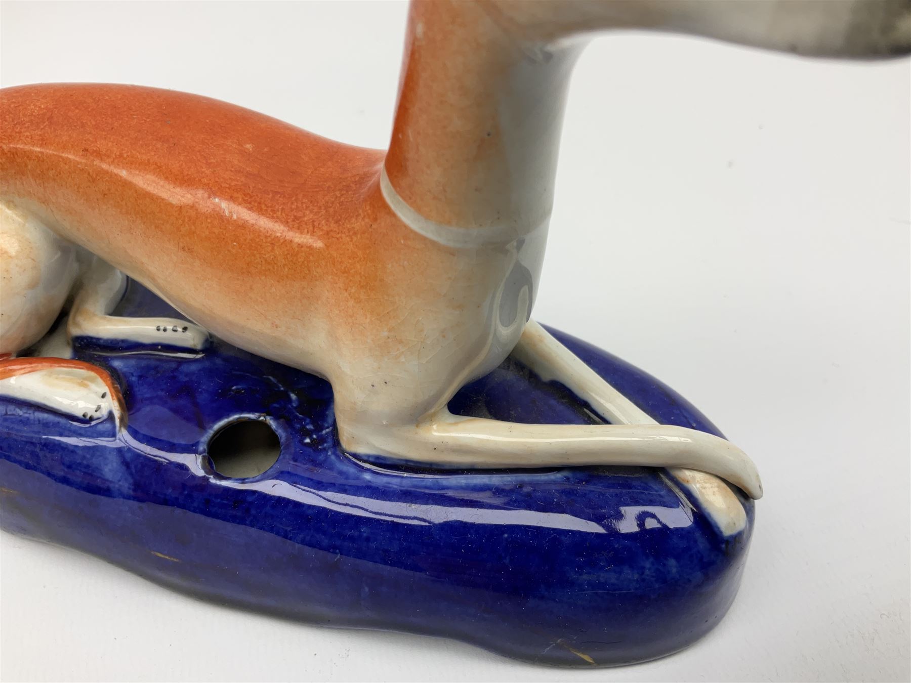 Pair of Staffordshire recumbent greyhound pen holders 