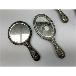 Glass dressing table tray, scent bottles and lidded bowl, metal mounted foliate design hair brushes and handheld mirrors etc