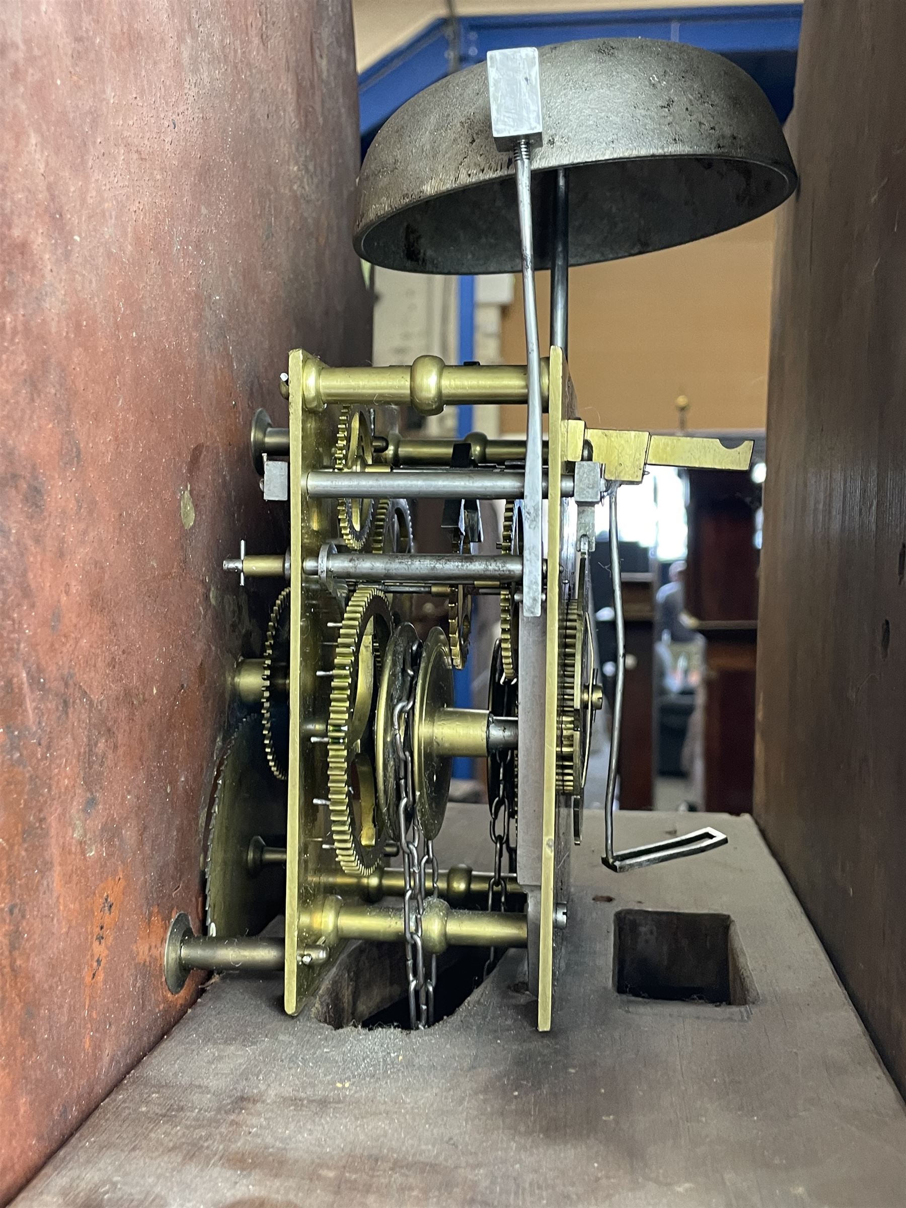 Early 19th century oak and rosewood banded longcase clock, scrolled pediment over stepped arch hood door, enamel painted dial indistinctly signed for a Penrith maker, 30-hour movement striking on bell