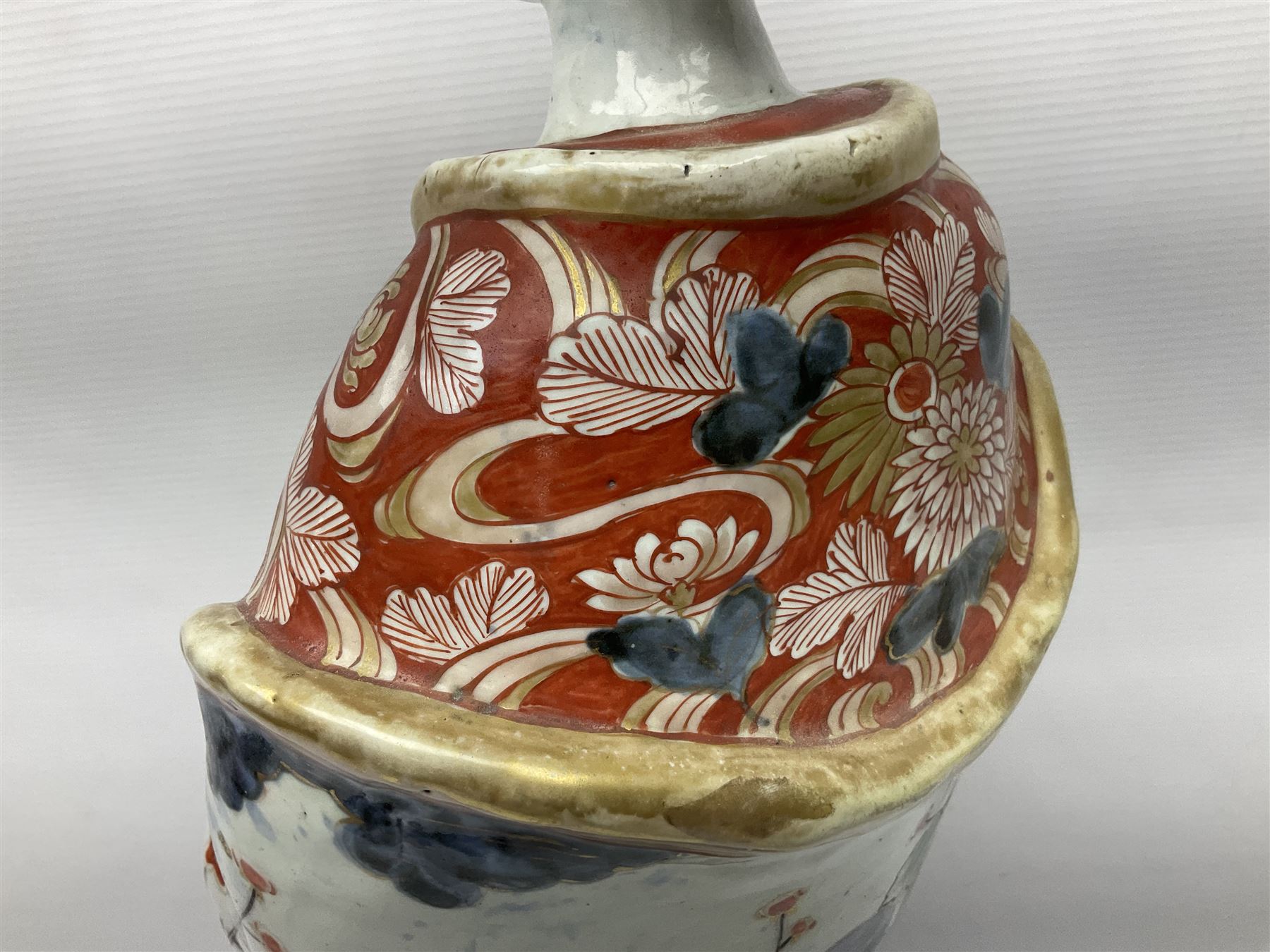 Large Japanese Imari porcelain figure, modelled as a Bijin, wearing a long kimono decorated with apple blossom and leafy branches on a white ground, with gilt detailing, possibly Edo period, H63cm