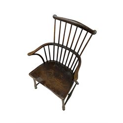 18th century country elm comb back Windsor chair, the eared cresting rail over hoop with curved arm supports, dished seat on turned supports with H stretchers