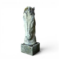 Large weathered cast stone horse head figure, raised on square plinth