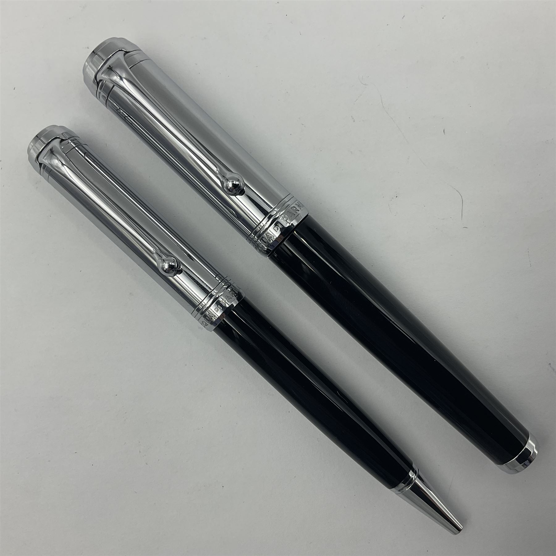 Acqua Di Parma for Aurora fountain pen, the black barrel with chrome mounts and cap, and white gold nib stamped 14K, together with a matching ballpoint pen, L13.5cm (2)