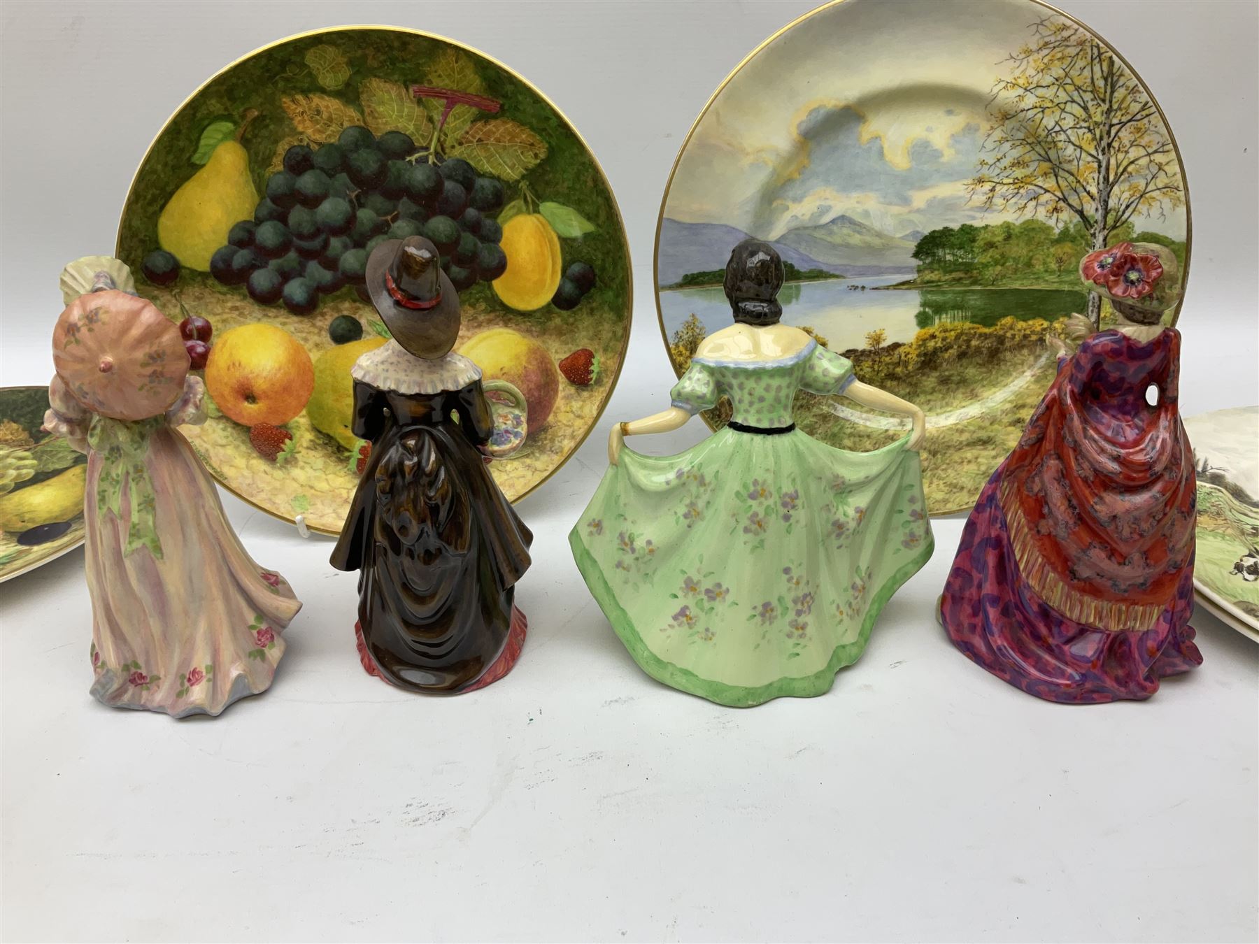 Four Frank Reynolds figures of ladies together with five plates painted by the same artist