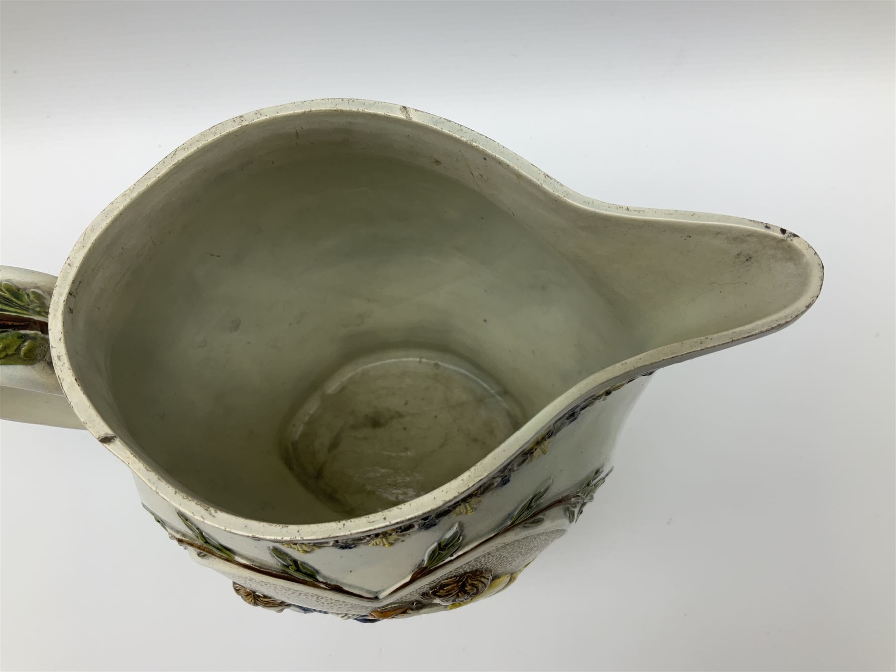 Early 19th century Prattware jug, circa 1800, decorated with two heart shaped panels of children, titled Sportive Innocence and Mischievous Sport, further decorated with acanthus and foliate borders, H22cm