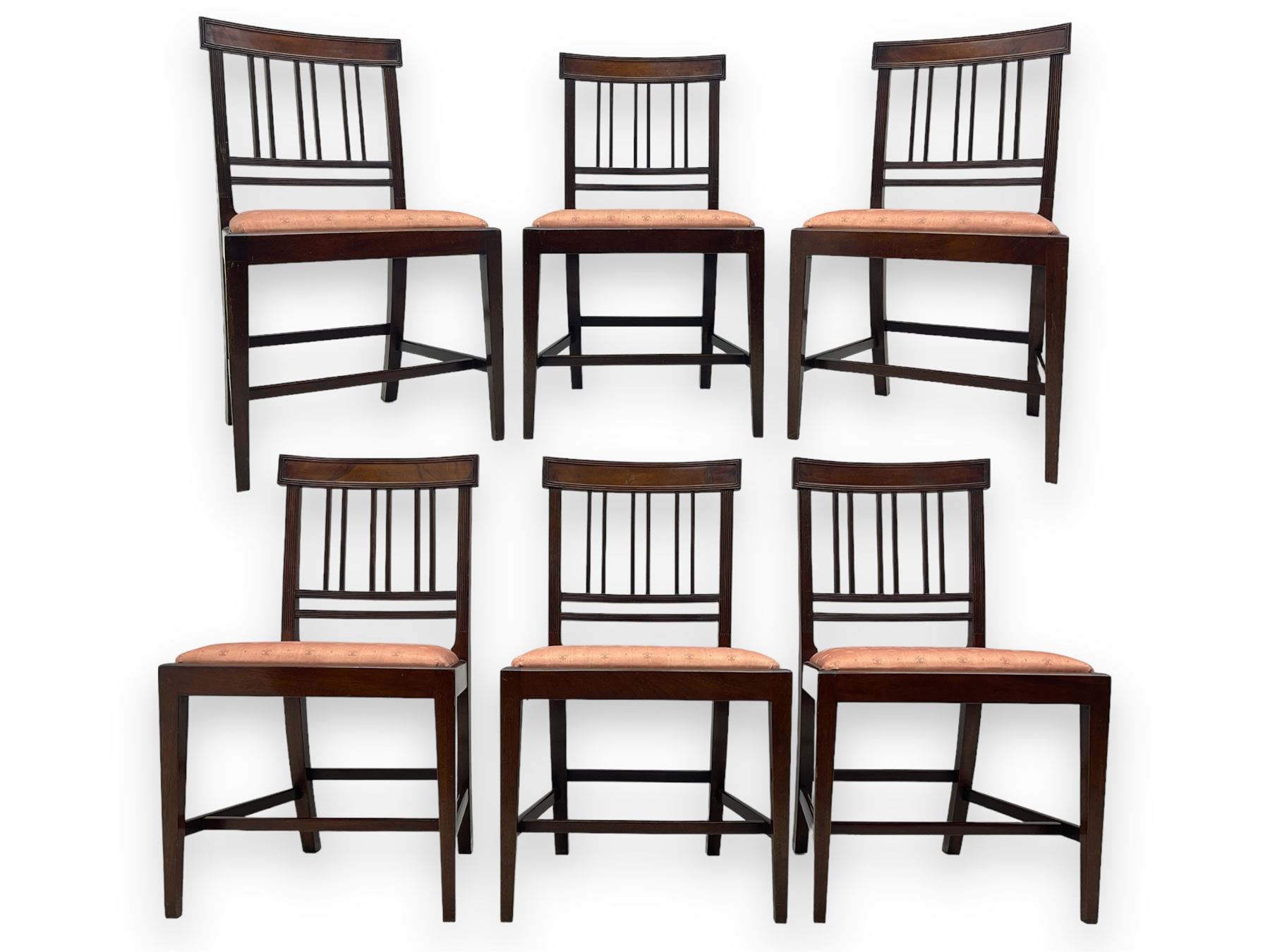 Early 20th century Regency design mahogany tilt-top table, circular top with edge banding, supported by a central turned pedestal with four reeded sabre supports terminating in castors; six chairs with pink upholstered drop in seats (7)