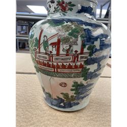 17th century Transitional period Chinese Wucai vase and cover, of baluster form, the body painted with ladies upon a terrace, and figures upon horseback and attendants within a fenced garden, the domed cover with knop finial painted with boys at play, H37cm
