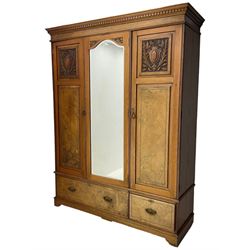 Late Victorian walnut triple combination wardrobe, projecting moulded and dentil cornice, central shaped bevelled mirror glazed door, cartouche and curled leaf carved panels over figured walnut veneered panels, fitted with drawer to base, on bracket feet