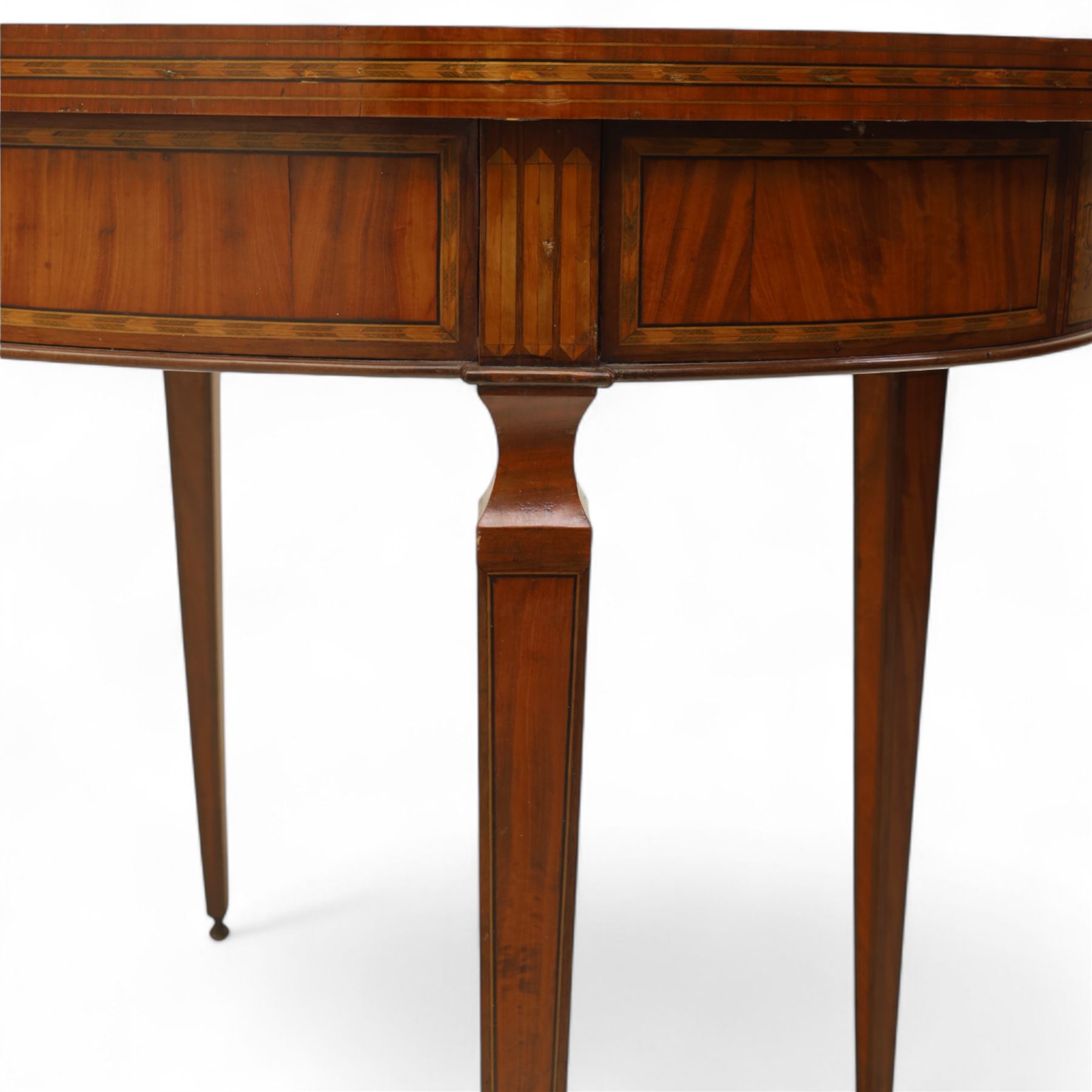 Aldam Heaton & Co (fl.1878-97) - late 19th century Sheraton revival style satinwood inlaid oval centre table, raised inlaid edge, centre with finely executed large central  inlaid medallion, surrounded by ribbon tied swags interspaced with medallions, frieze with rectangular symmetrical panels of foliate sprays of acanthus leaves, raised on four square section tapering legs with cavetti shaped shoulders with stringing on brass bulb feet, underside with bone plaque signed Aldam Heaton & Co, Baker St, London