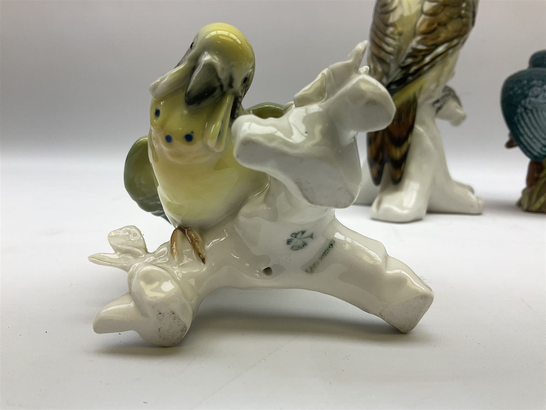 Karl Ens figure of a green woodpecker, modelled perched upon branch, model no. 7527, together with Karl Ens figure of budgie and Beswick Kingfisher no. 2371, all with printed marks beneath, tallest H25cm
