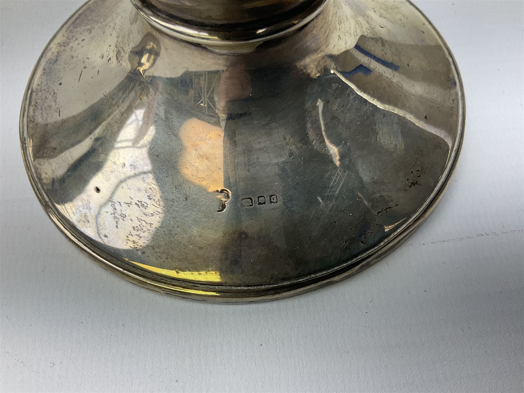 1920's silver mounted capstan inkwell, hallmarked Charles Boyton & Son Ltd, London 1929, together with an early 20th century silver mounted dwarf candlestick, hallmarked A J Pepper & Co, Birmingham 1918