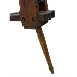 Early 19th century cobbler's work bench, in various woods, revolving cast iron last on yew wood supports, pine seat with inset maker's plaque inscribed 'No 7 Josh Blacker Harehills Leeds', on turned elm front supports and turned beech rear supports 