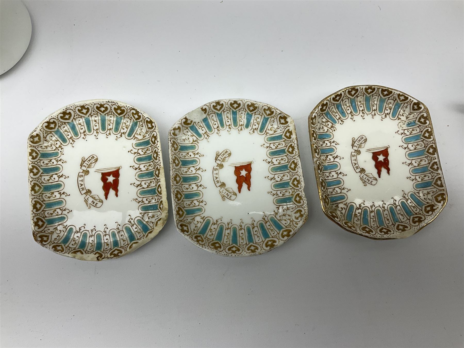 White Star Line, six pieces of porcelain by Stonier & Co. Liverpool, comprising four tea cups, three saucers, jug and three pin trays, registered design no. 117214/324028, printed mark beneath 