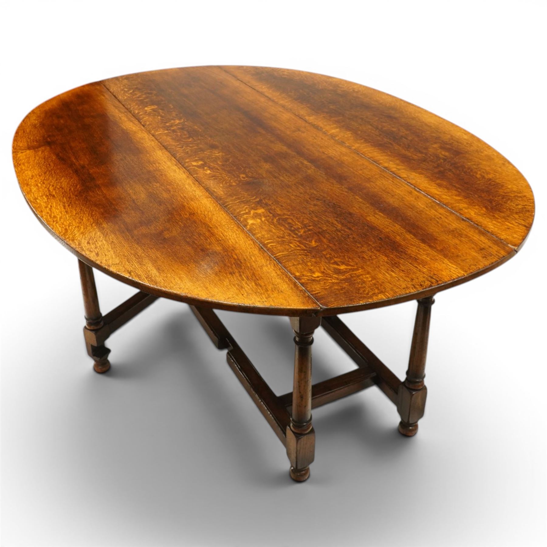 Titchmarsh & Goodwin - oak dropleaf wake table, large leaves with gateleg action, raised on turned supports united by stretchers, extends to 148cm