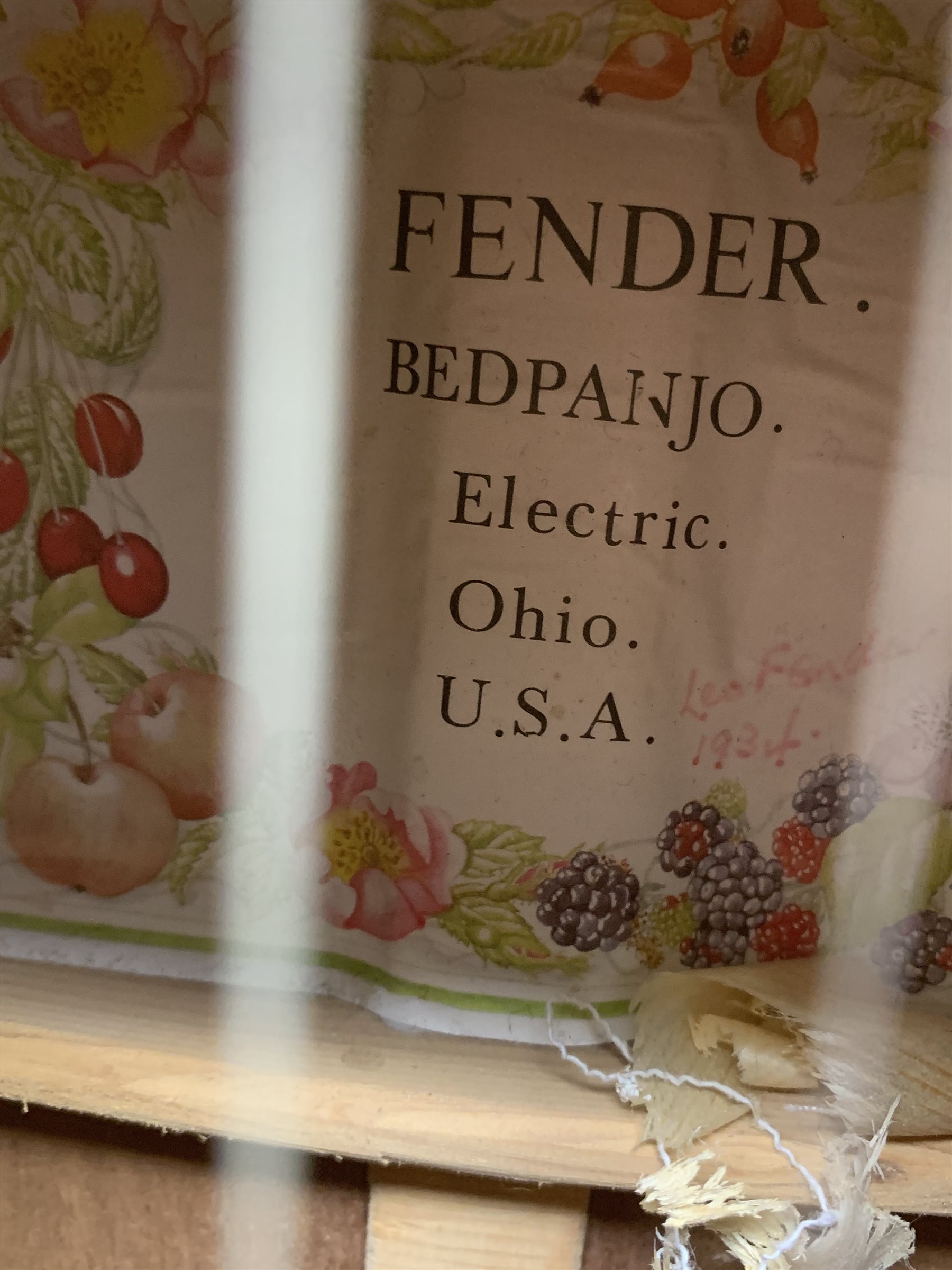 Four-string banjo guitar with mahogany circular back and sides and spruce top, mother-of-pearl inlaid fingerboard and headstock, bears humorous label 'Fender Bedpanjo', L95cm