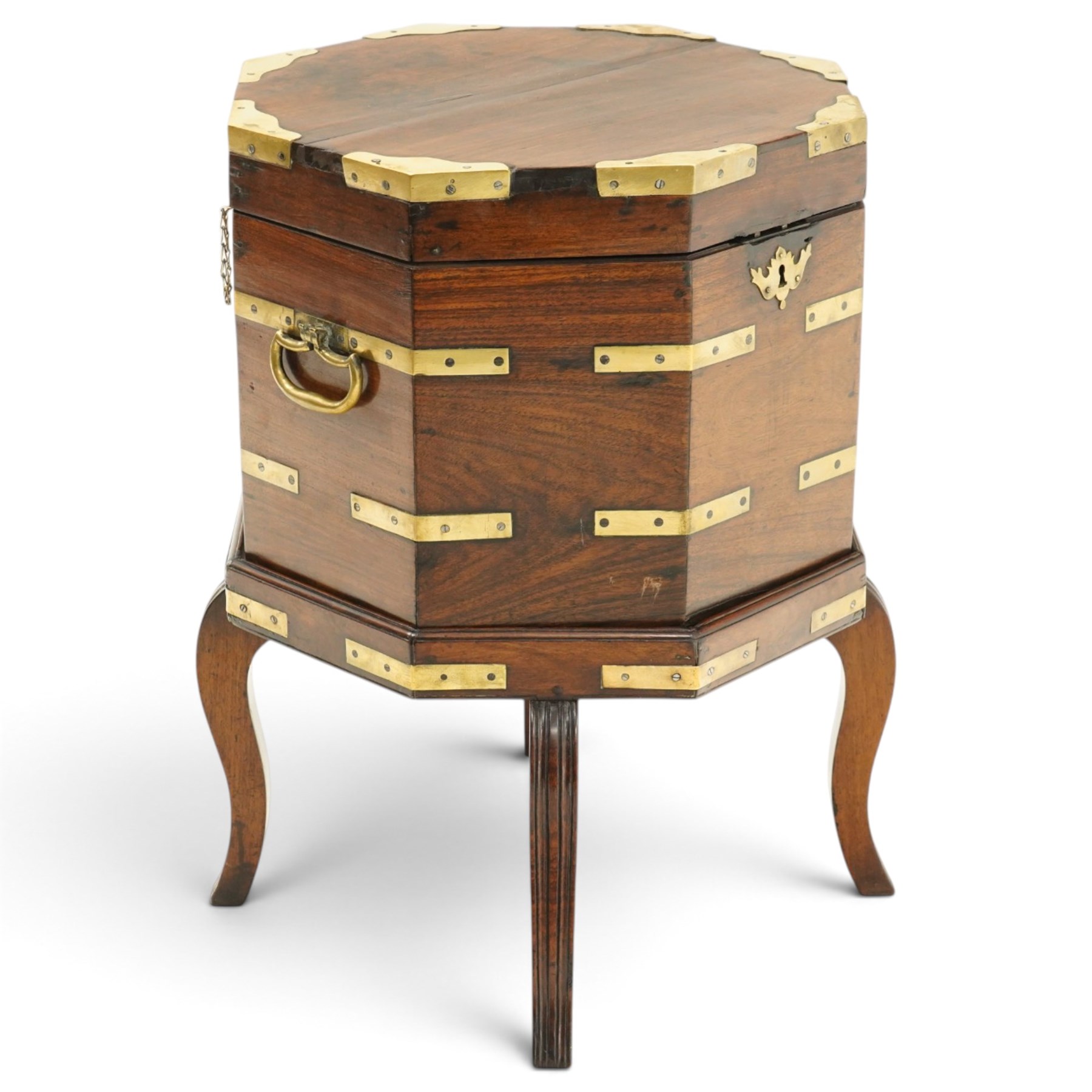 Late 18th century Anglo-Indian padouk and brass-bound octagonal cellarette or wine cooler, the hinged lid enclosing a vacant interior, the panelled body with applied brass strapwork, pierced escutcheon and side carrying handles, raised on a separate stand terminating to four fluted and reeded cabriole supports