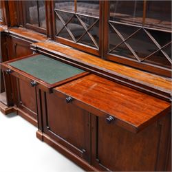Large Georgian mahogany library bookcase, projecting moulded cornice with row of globular mounts, adjustable shelving enclosed by six astragal glazed doors, fitted with two slides and six panelled cupboard doors, two banks of five drawers, on moulded plinth base; together with two pairs of associated astragal glazed doors in mahogany, from the same property (W55.5cm x H168cm & W48cm x 168cm)