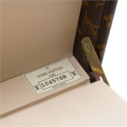 Late-20th century Louis Vuitton monogram Boîte Flacons vanity coffret, monogram canvas with lozine trim and brass mounts, single front brass lock stamped Louis Vuitton with key code 1247413, the interior fitted with leather flacon retaining loops and lift-out lidded tray with leather handle, label to interior printed Louis Vuitton Paris serial number 1045768, together with two keys stamped with matching serial numbers to the lock and luggage tag, circa late 1990s-early 2000s
