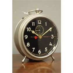  Early to mid 20th century 'Goliath Repeater' circular polished metal alarm clock, black dial with Arabic numerals, subsidiary alarm dial, twin coil H.A.C movement, D14cm (excluding handle)    