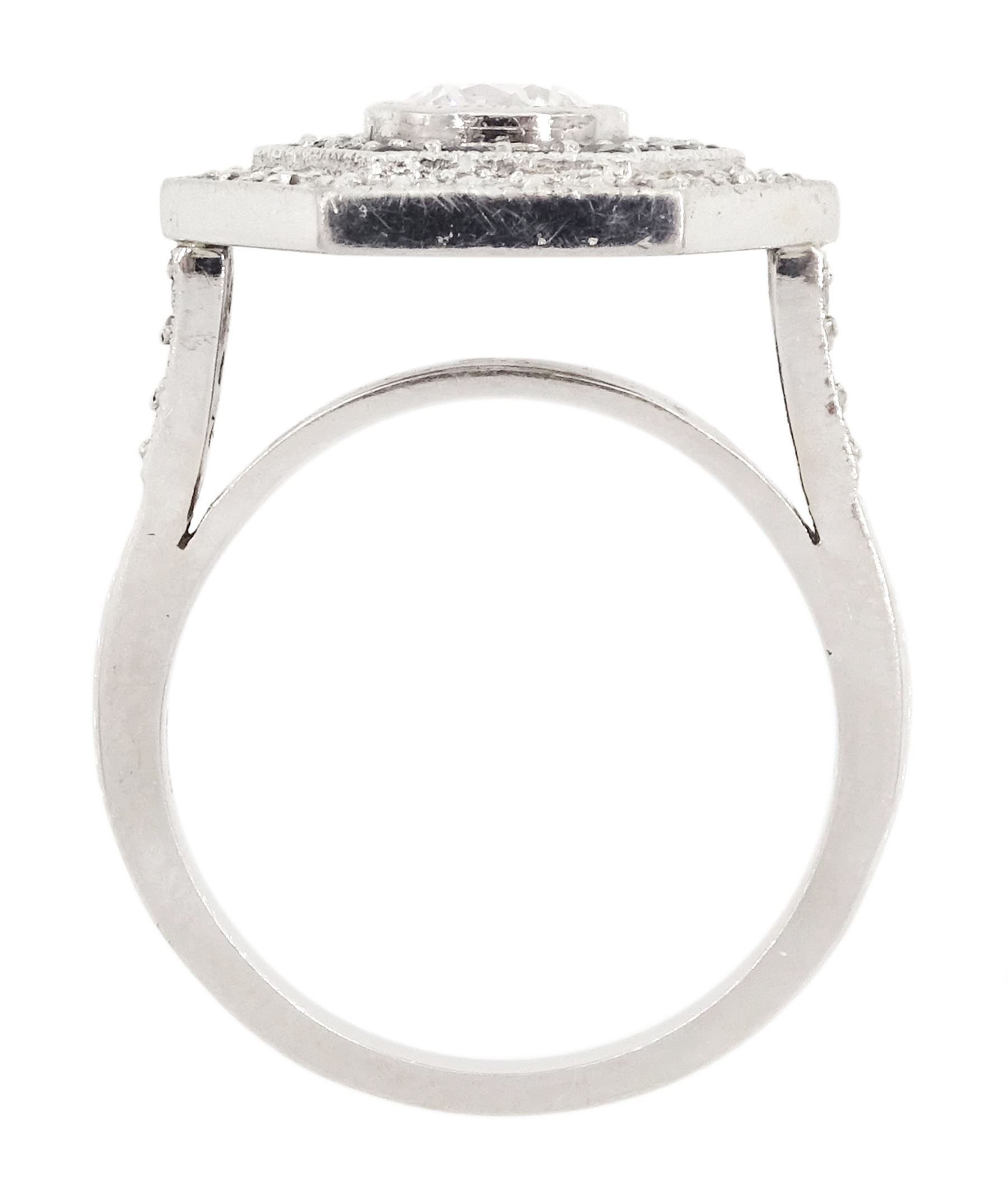 Platinum diamond and sapphire hexagonal ring, the principle diamond of approx 0.55 carat, with sapphire and round brilliant cut diamond surround, all milgrain set, hallmarked