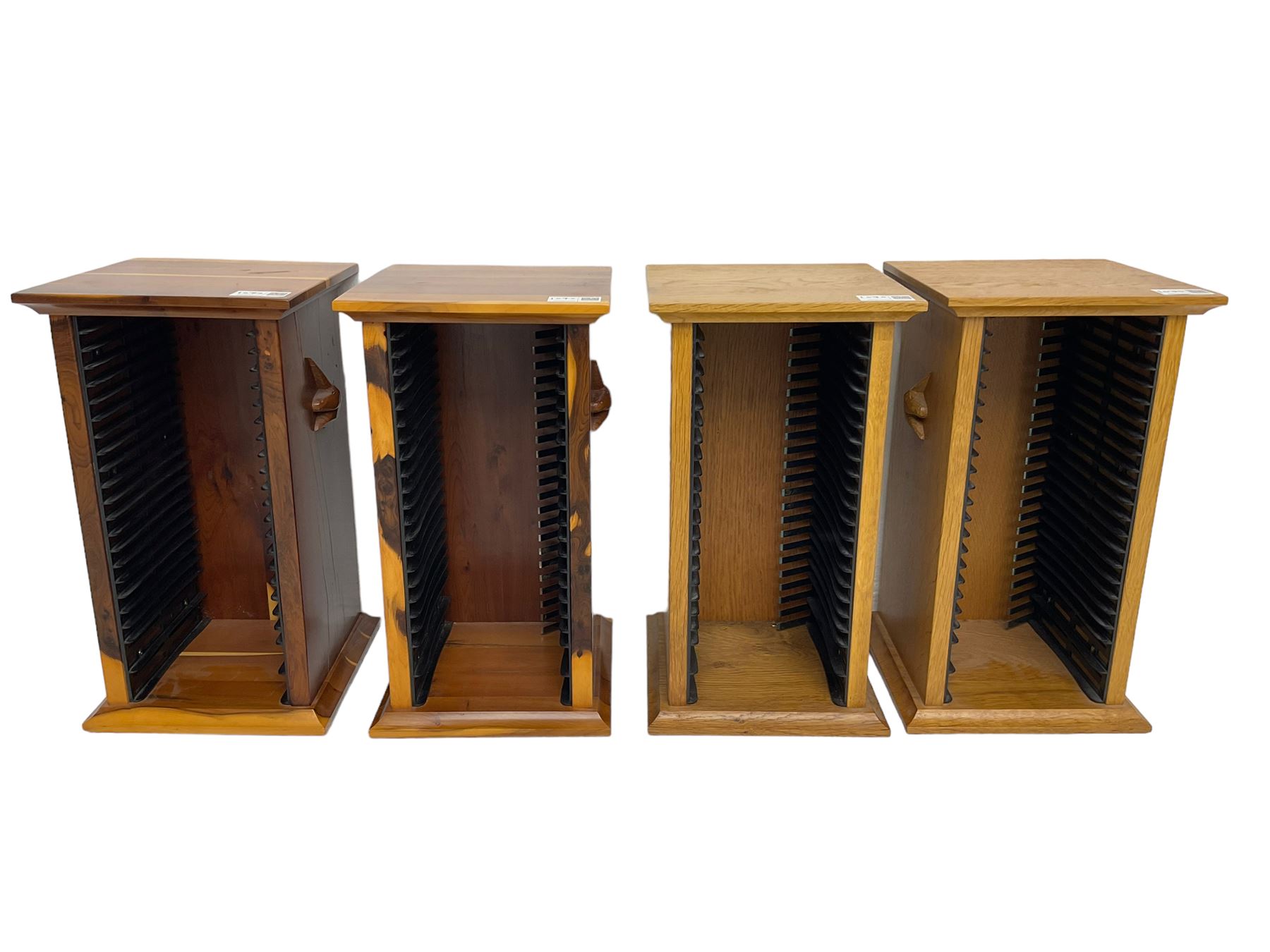 Unicornman - yew wood cabinet, moulded hinged lid over two panelled doors and shelves (W56cm, H99cm, D45cm); and four Unicorn man CD racks two in yew wood and two in oak (W20cm, H36cm, D20cm); all carved with unicorn signature and by Geoff Gell, Coxwold
