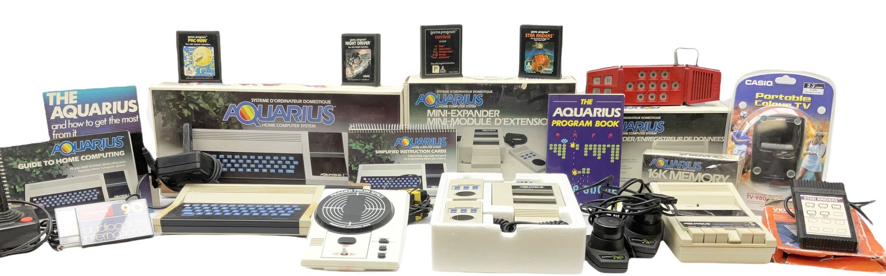 Mattel Aquarius Home Computer System c1982/3, with Mini-Expander, Data Recorder and 16K Memory, all boxed, and two instruction booklets; Grandstand Invader From Space and Palitoy Merlin electronic games; unopened blister packed Casio Portable TV-980; and quantity of game accessories