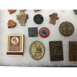 Over seventy German awards and badges etc including Winter help Work tinnies, Cholm 1942 arm shield, 'SS' second type skull, Wound badge, workers badge, 1920s Imperial Tank badge, terracotta charms etc; displayed in two glass topped boxes