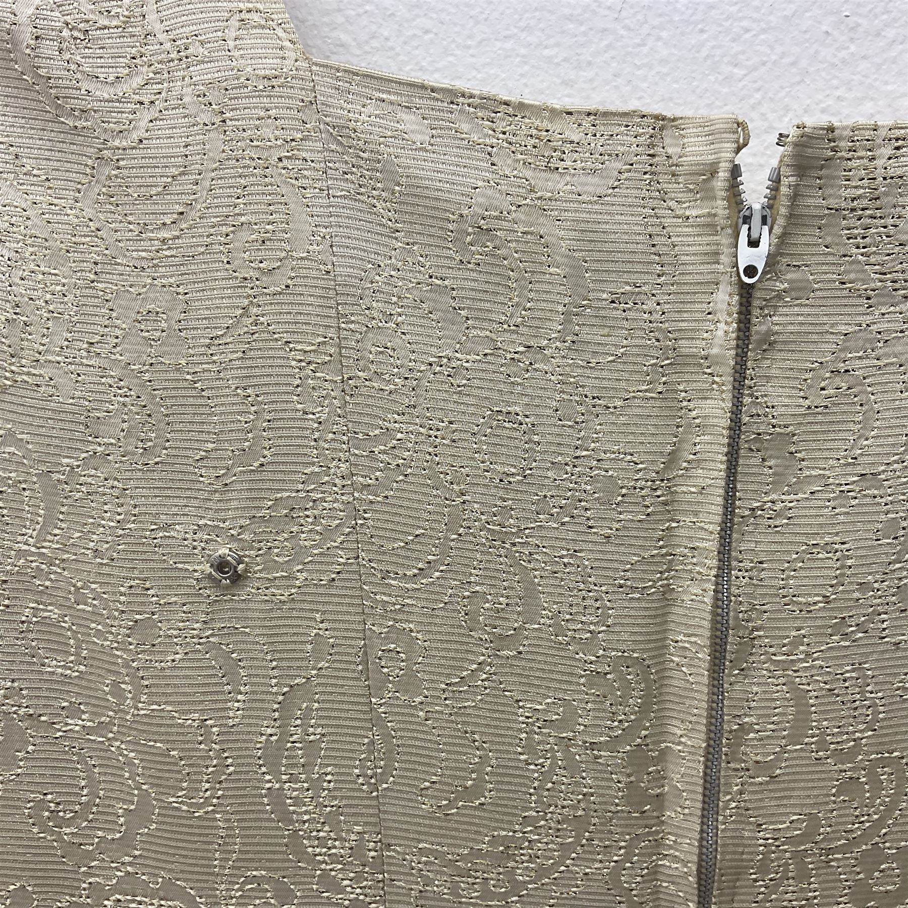 WW2 British female ATS Sergeant's service uniform grouping, consisting of four pocket female pattern service dress tunic with brass ATS shoulder titles and general service buttons; cloth lined interior with the original printed size label dated 1942; the matching khaki service dress skirt; and Greatcoat with size label dated 1945; together with army knitted sleeveless V-neck jumper; WRAC tunic, skirt and overcoat; full length cream and gold thread military evening dress by Hilliers Couture; and four webbing belts