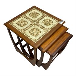 G-Plan - 'Astro' nest of three teak occasional tables, the largest with inset tiled top, on shaped end supports