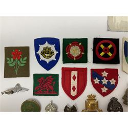 Thirty-six British metal and cloth badges including RAOC, Wiltshire Regiment, West Yorkshire Regiment, ARP, Princess of Wales's etc