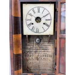 An American Ogee shelf clock in a contrasting mahogany veneered case,c1890, with a square painted dial, Roman numerals and minute track, rear painted glass tablet beneath depicting a rose withing a decorative border, eight-day weight driven movement by E.N. Welch, striking the hours on a bell. With key and pendulum.
