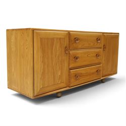 Ercol - mid-20th century light elm and beech Windsor 'model 455' sideboard, rectangular top over three central drawers flanked by cupboards, on castors