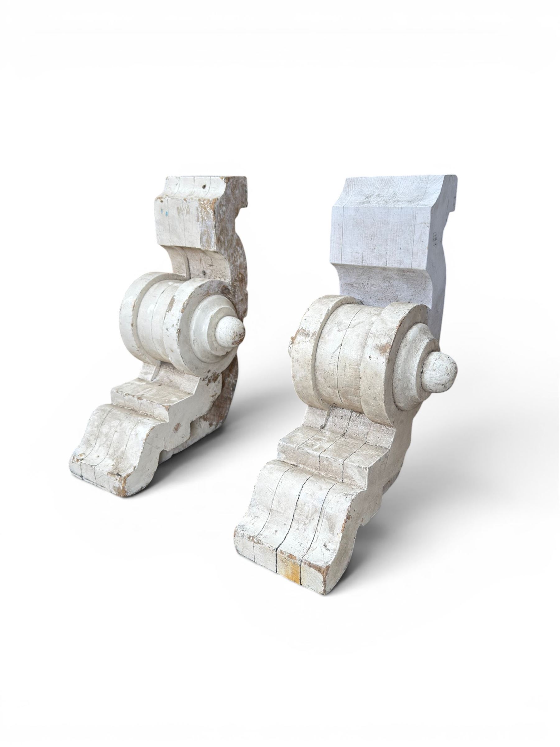 Pair of 19th century stripped pine columns  with carved capitols; an a pair of painted scroll architectural capitols (4)