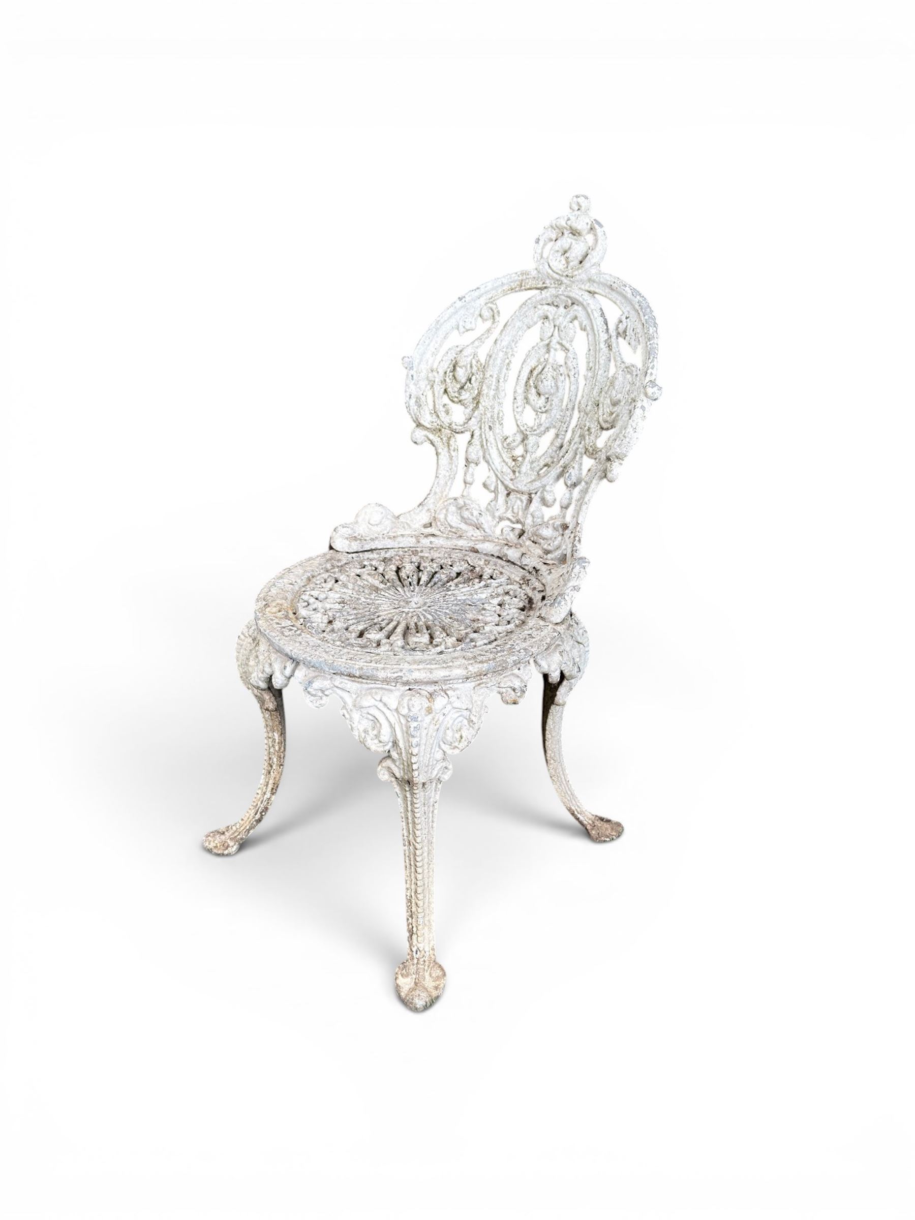 Pair of white painted cast metal garden chairs, ornate reclined backs, circular pierced seats on cabriole legs