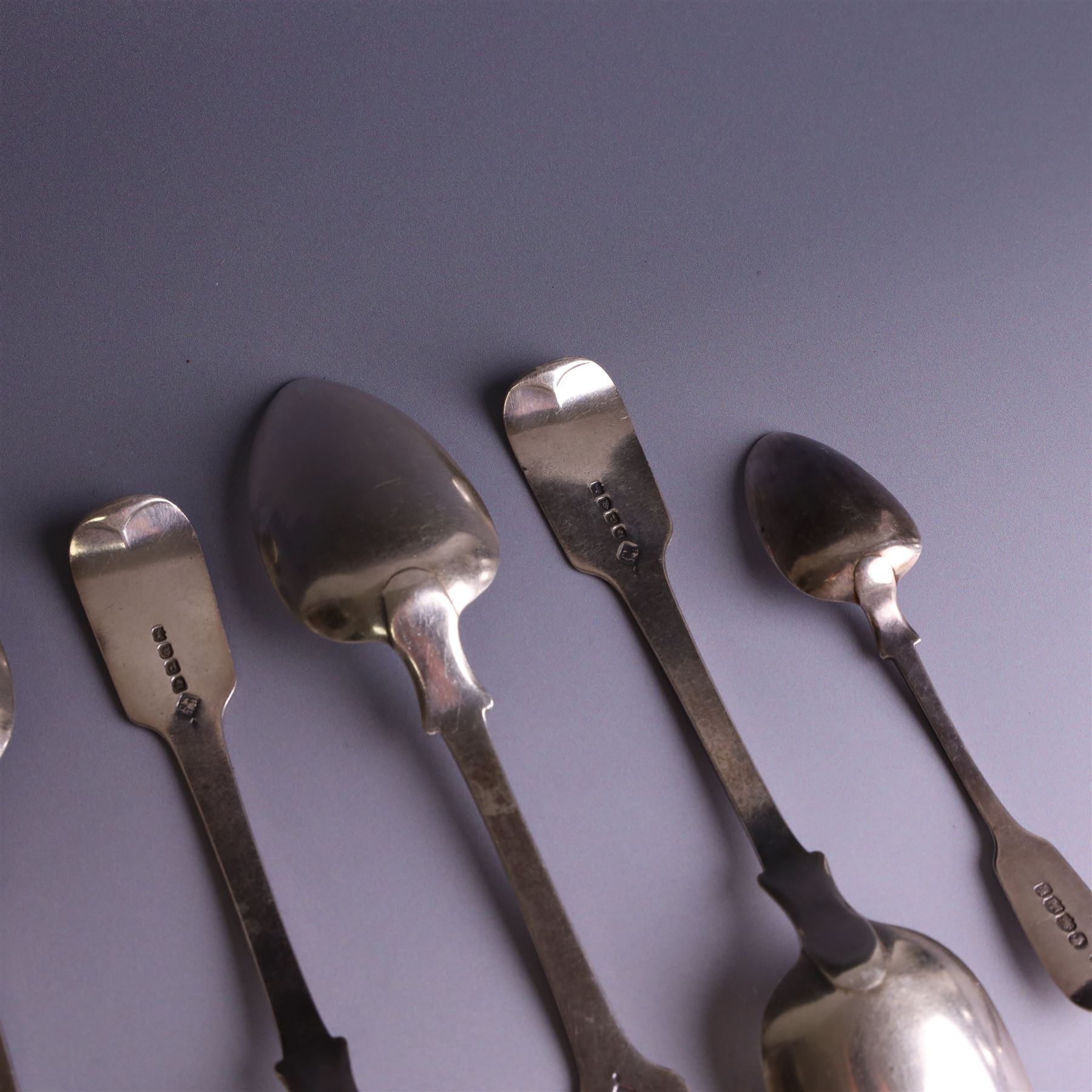 Set of four George III silver Fiddle pattern table spoons all engraved with monogram, hallmarked Thomas Wallis (II) & Jonathan Hayne, London 1819, together with a  Victorian silver Fiddle pattern teaspoon with engraved initials, hallmarked William Rawlings Sobey, Exeter 1846