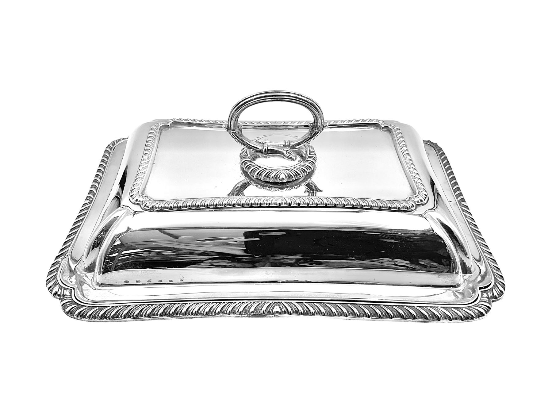 Early 20th century silver entree dish and cover, of rectangular form with shaped corners and oblique gadrooned borders to base and cover, the cover with loop 'bamboo' handle, hallmarked Thomas Bradbury & Sons Ltd, Sheffield 1930, including handle H10.5cm L24.5cm