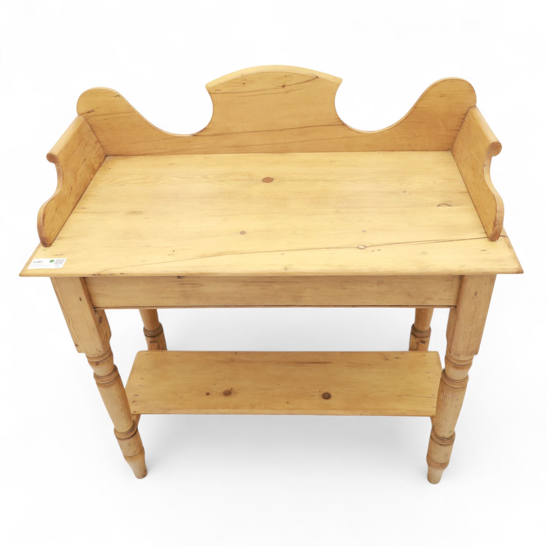 20th century pine washstand, shaped three-quarter gallery back over rectangular top, raised on turned supports with lower undertier