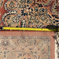 Persian Kashan rug, the rich terracotta field with central floral medallion and palmette spandrels, surrounded by a cream border of stylised boteh and foliate decoration