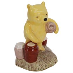 Sixteen Royal Doulton Winnie the Pooh figures, including Pooh's Blue Balloon money box, Winnie the Pooh in the Armchair, Piglet Picking Violets and Eeyore's Birthday etc, fifteen with boxes