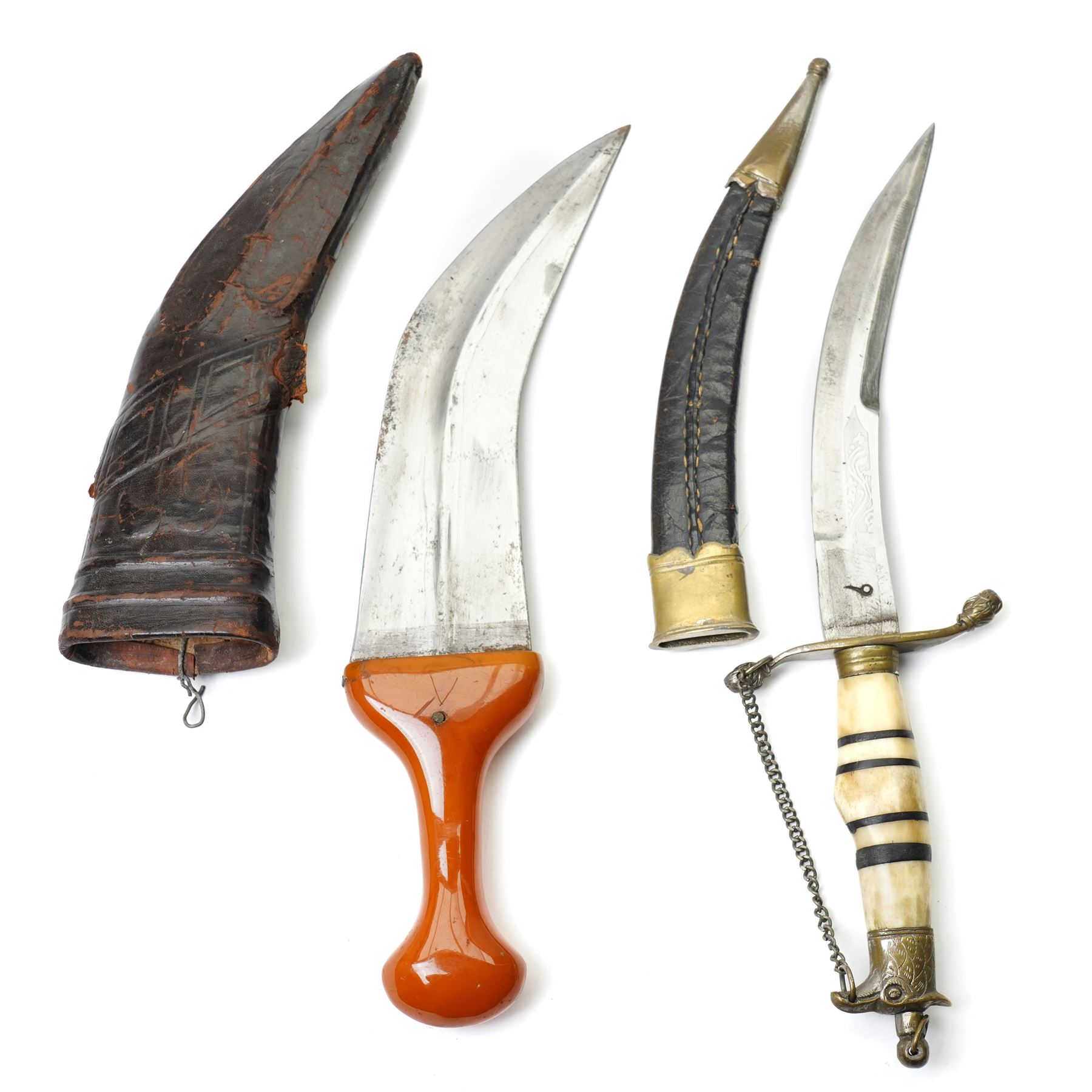 Arab jambiya with simulated amber handle and leather sheath, African dagger with horn handle and a copper shot flask (3) 