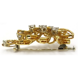  18ct gold diamond floral brooch, six principle diamonds and diamond set leaves stamped 750, 4.4cm approx 10.3gm  
