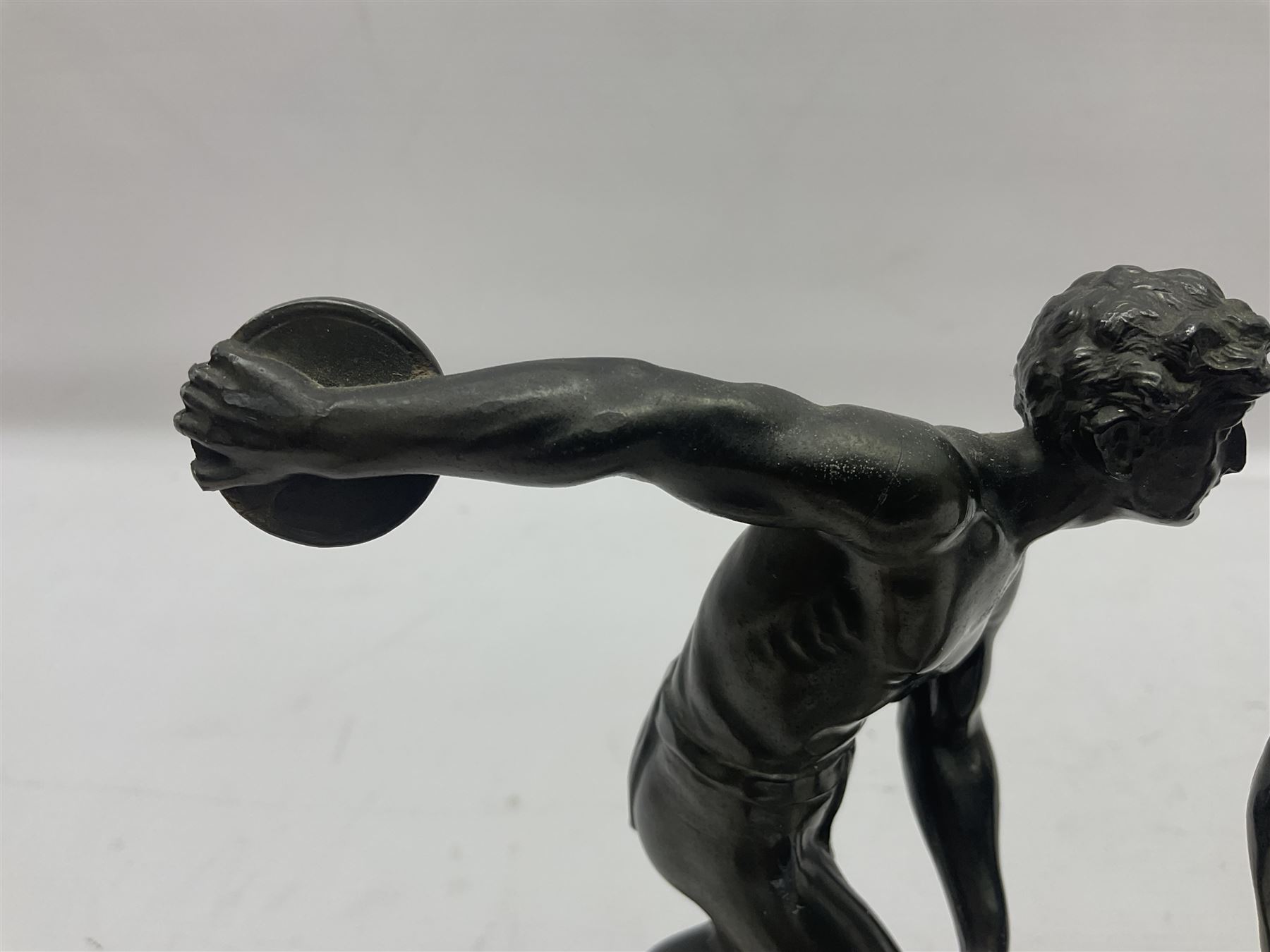 Bronzed model of the discus thrower and another of a episkyros player, both raised upon retangular plinths, H18cm