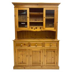 Traditional pine dresser, the rack fitted with two shelves flanked by glazed cupboards, the base with three drawers over three panelled cupboards