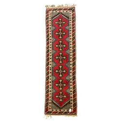 Turkish red ground runner, the field decorated with seven geometric star motifs, repeating geometric patterned border