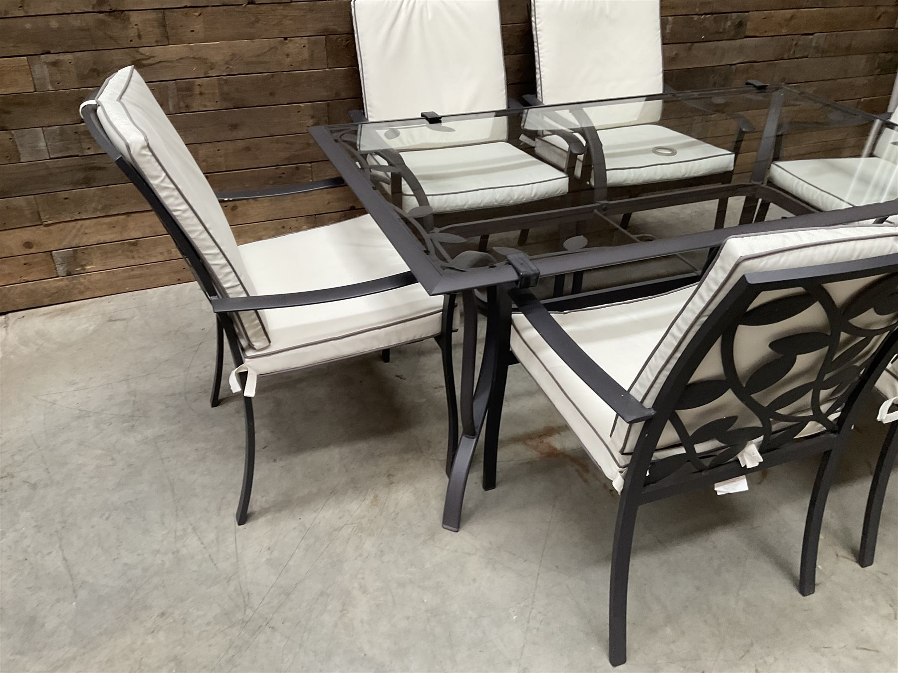 Metal framed garden table with glazed top (W170cm, D102cm, H71cm) and six armchairs with cushions 