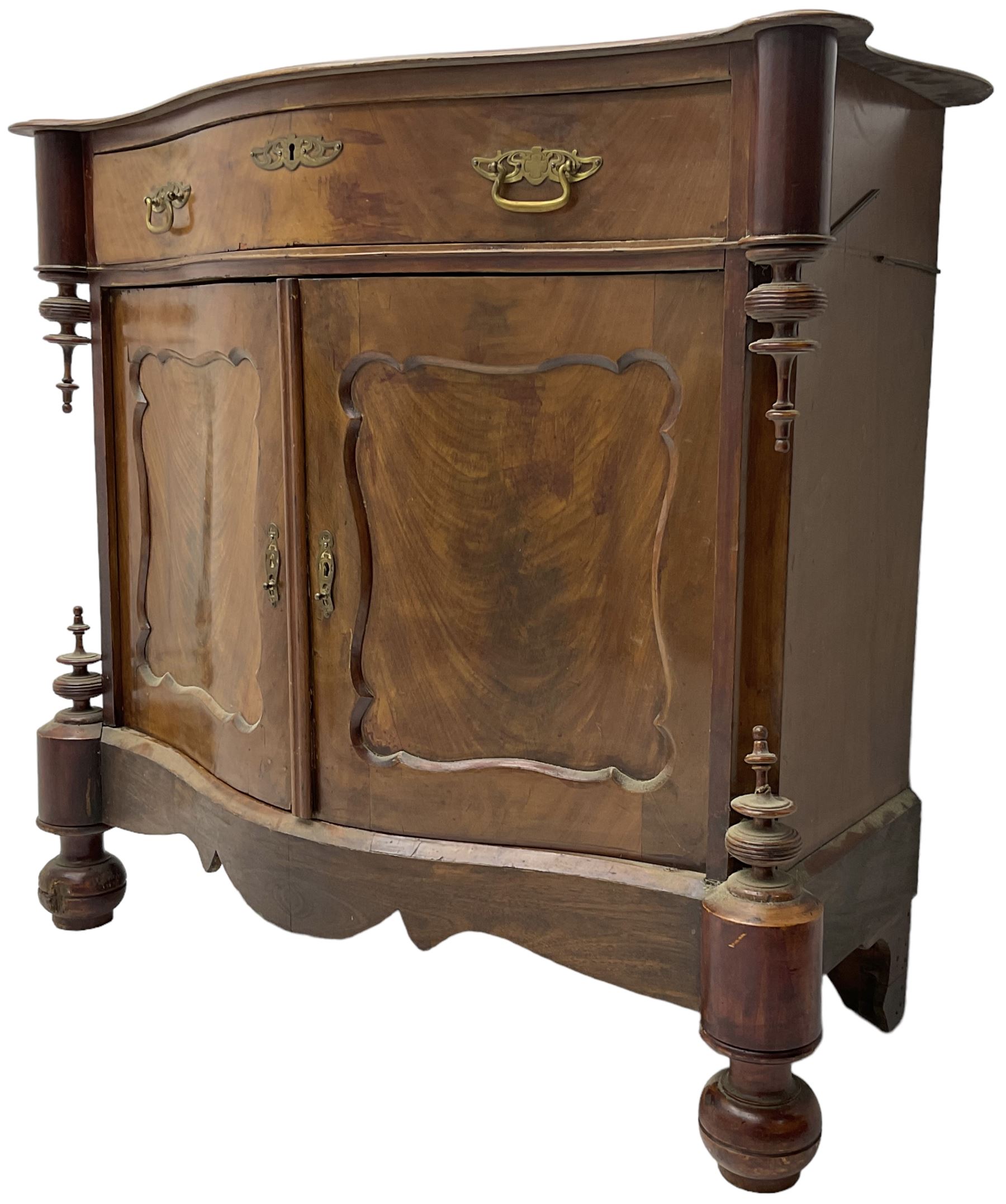 Victorian mahogany serpentine side cabinet, fitted with single drawer over panelled cupboard enclosing single shelf, raised on turned bun feet