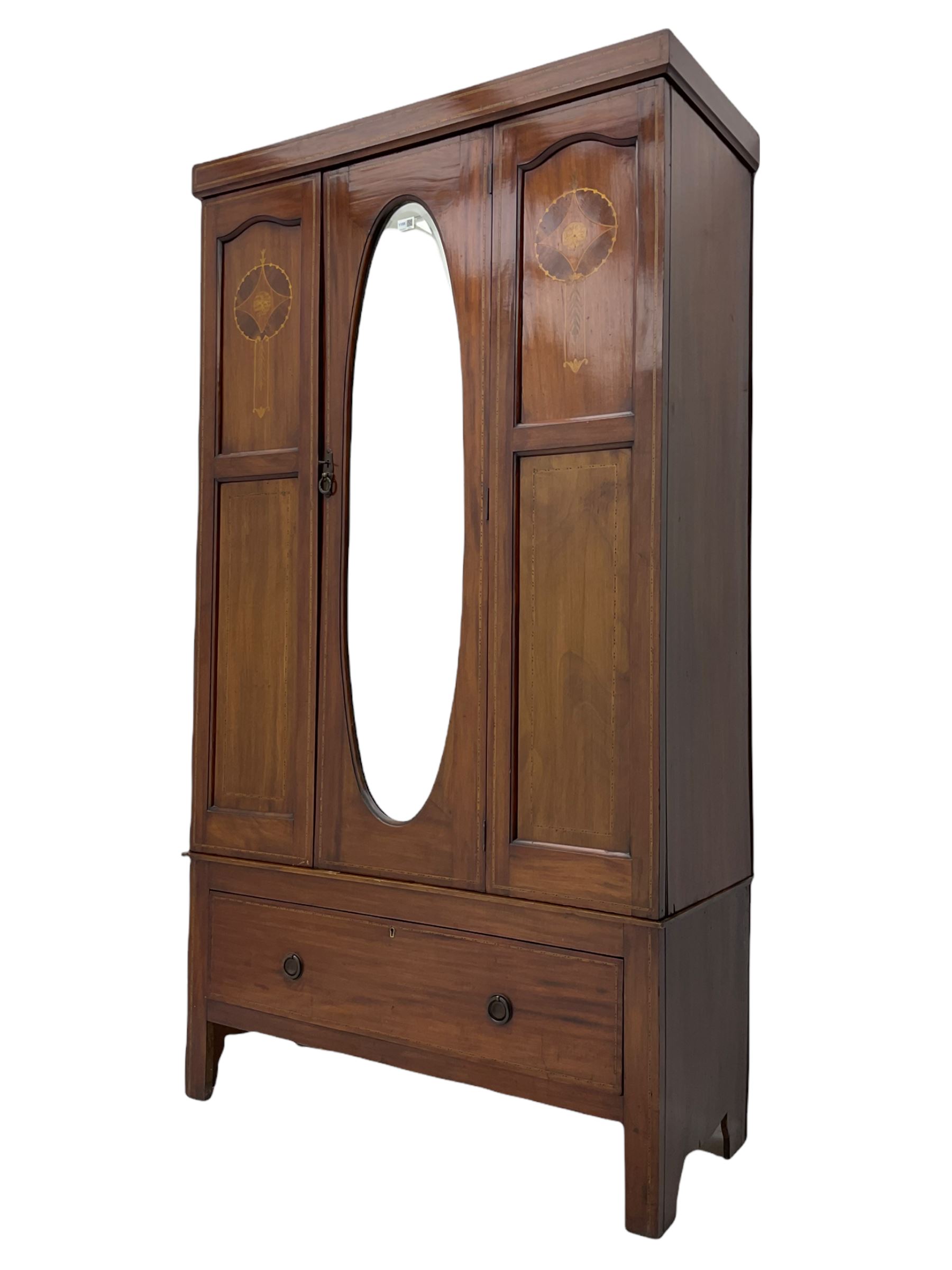 Edwardian inlaid mahogany wardrobe, oval mirror door, single drawer to base