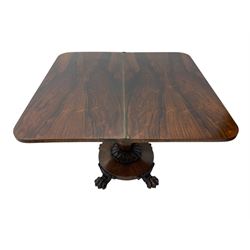 Victorian mahogany tea table, rectangular top with rounded corners, folding and swivelling to reveal interior surface, supported on a faceted baluster-shaped column, raised on a circular platform base with carved acanthus details, ending in four lion paw feet