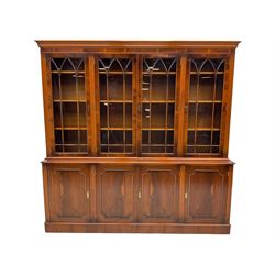 Georgian design yew wood bookcase on cupboard, four glazed doors above four cupboards, adjustable shelves