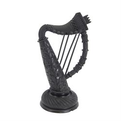 19th century Irish carved bog oak model of a harp, detailed with fluting, diamond cuts and shamrocks, upon a turned circular base, H29cm
